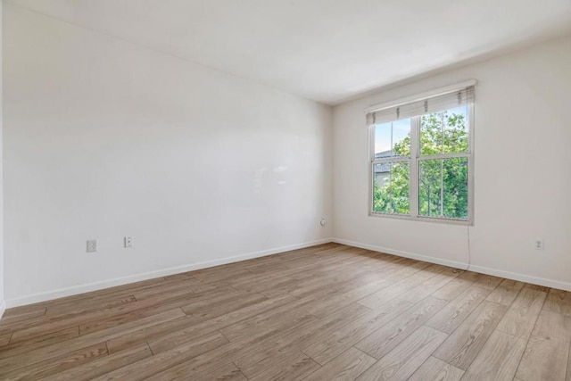 spare room featuring light hardwood / wood-style flooring