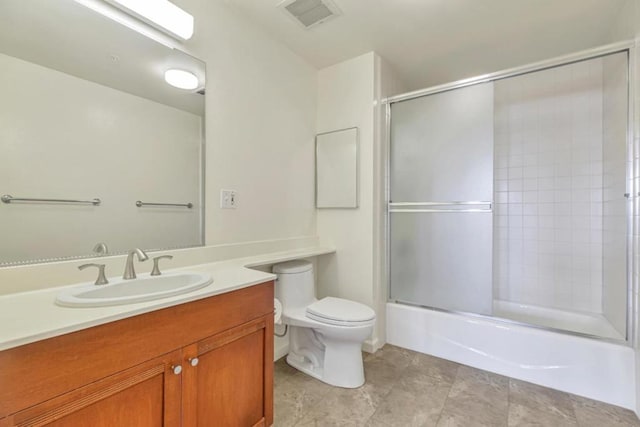 full bathroom with toilet, vanity, and shower / bath combination with glass door