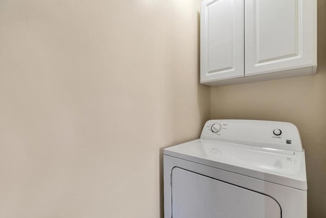 washroom featuring washer / clothes dryer and cabinets