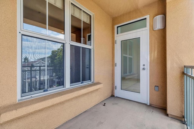 entrance to property featuring a balcony