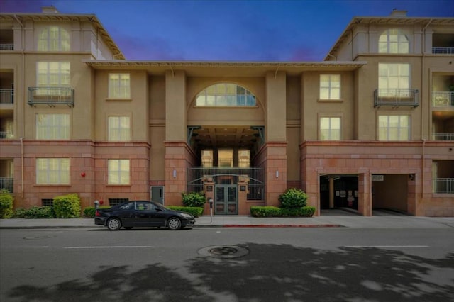 view of outdoor building at dusk