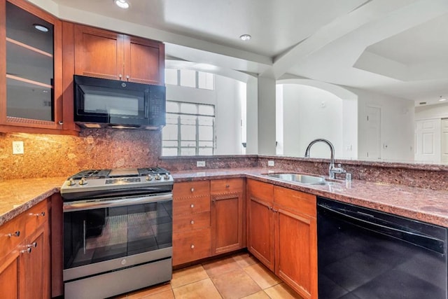 kitchen with black appliances, sink, backsplash, light stone counters, and light tile patterned floors