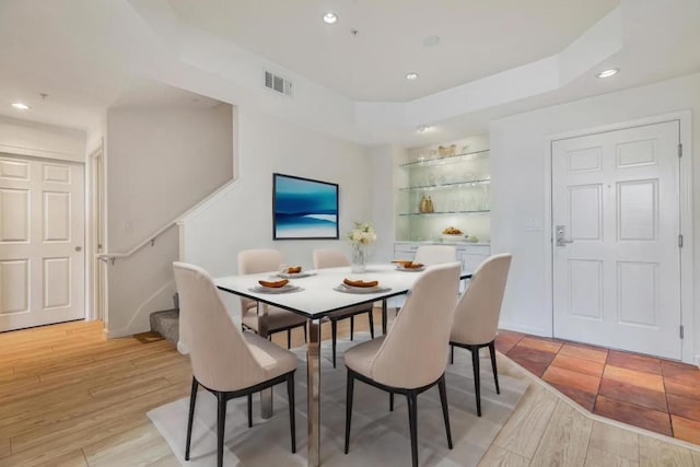 dining area featuring built in shelves and light hardwood / wood-style flooring