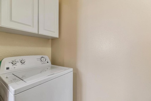 laundry area with cabinets and washer / dryer