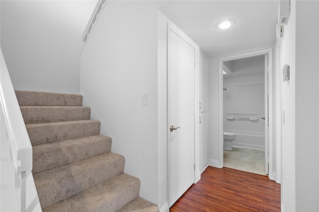 staircase featuring hardwood / wood-style floors