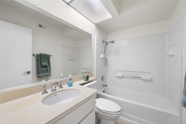 full bathroom featuring toilet, tiled shower / bath, and vanity