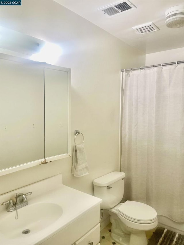 bathroom with toilet, vanity, and a shower with curtain