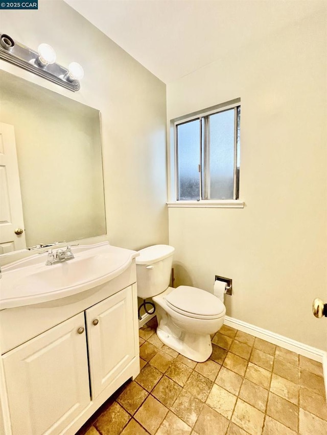 bathroom featuring toilet and vanity