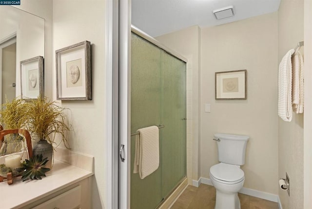 bathroom featuring toilet and a shower with shower door