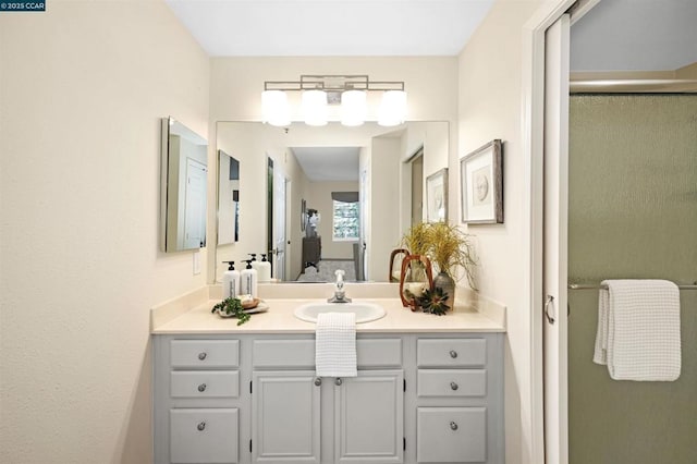 bathroom featuring an enclosed shower and vanity