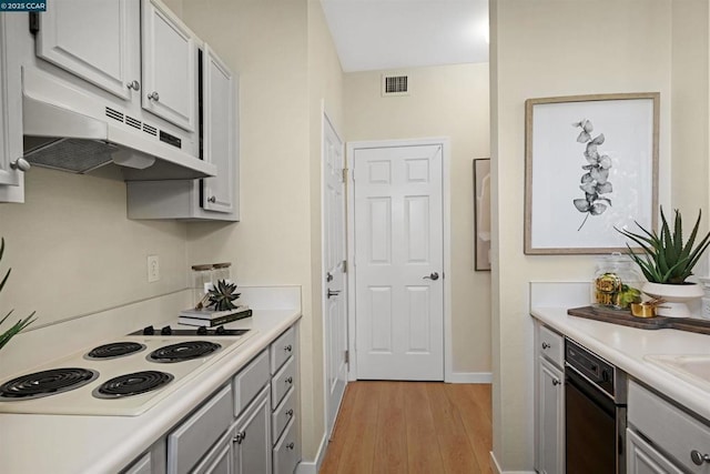 kitchen with light hardwood / wood-style floors and white stovetop