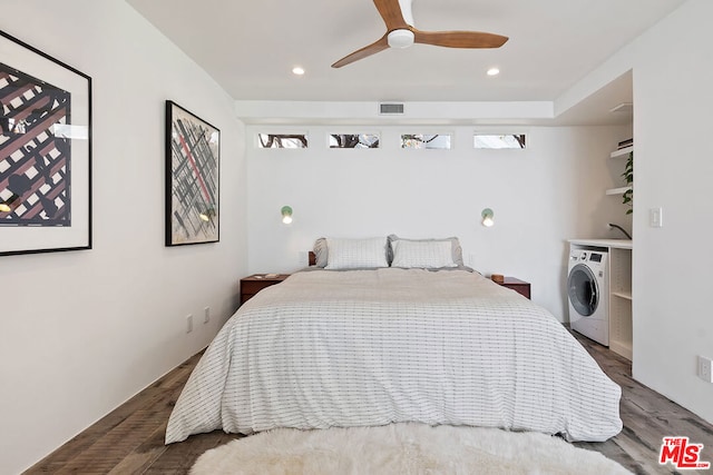 bedroom featuring ceiling fan, dark wood-type flooring, and washer / clothes dryer