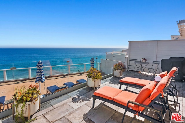 balcony with a water view and grilling area