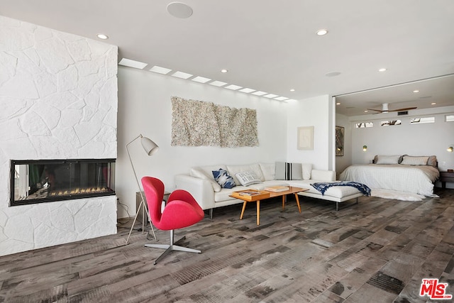 bedroom featuring hardwood / wood-style flooring and a fireplace