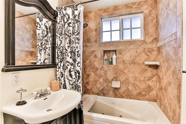 bathroom featuring a combined bath / shower with jetted tub and a sink