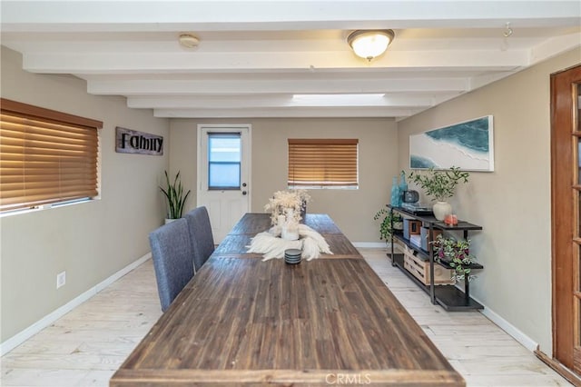 dining area with beamed ceiling, light wood-type flooring, and baseboards