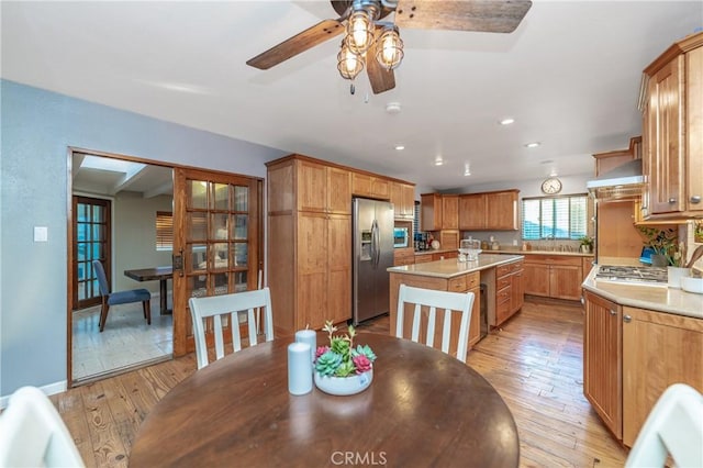 dining area featuring light wood finished floors, baseboards, a ceiling fan, and recessed lighting