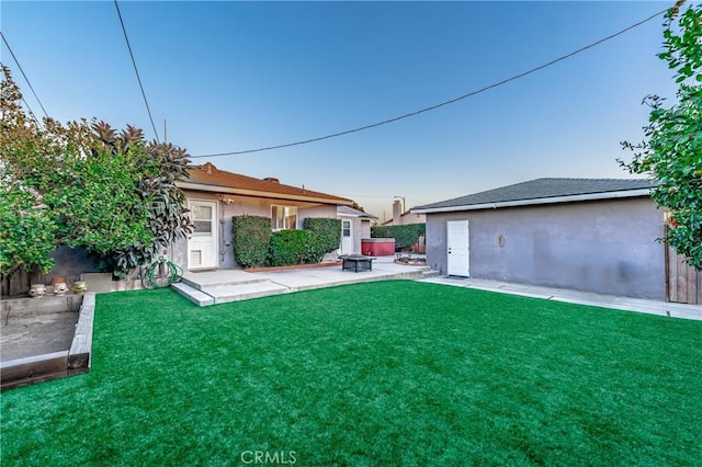 view of yard with a fire pit, a patio area, and fence