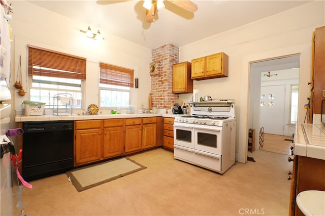 kitchen featuring ceiling fan, light colored carpet, double oven range, black dishwasher, and tile counters