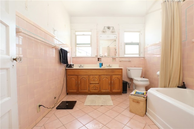 bathroom with toilet, tile walls, tile patterned floors, and vanity