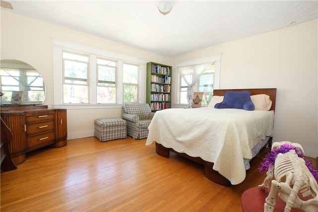 bedroom featuring light hardwood / wood-style floors and multiple windows