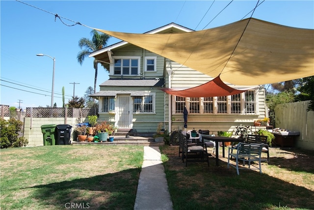 back of house featuring a lawn