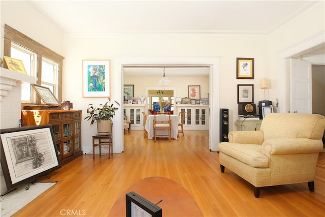 sitting room featuring crown molding and hardwood / wood-style flooring