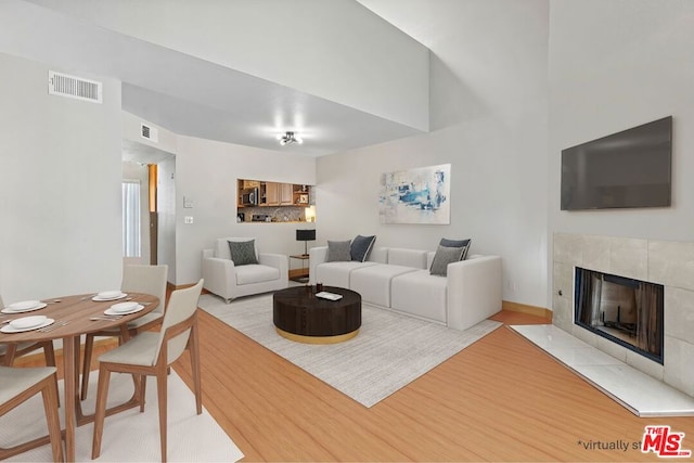 living room featuring a fireplace and light hardwood / wood-style flooring