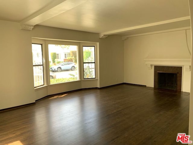 unfurnished living room with a healthy amount of sunlight, a fireplace, and dark hardwood / wood-style flooring