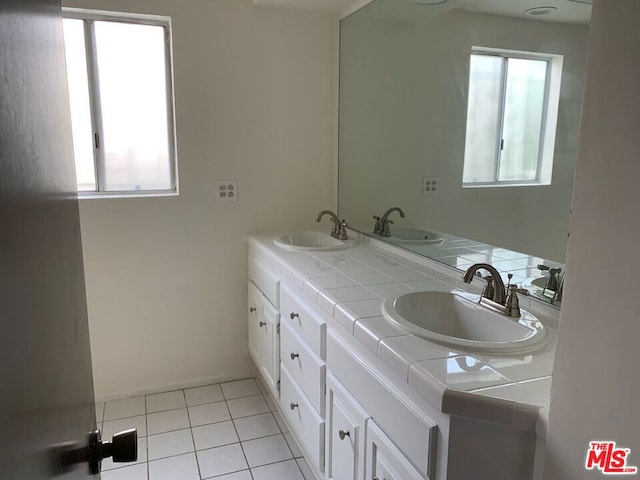 bathroom with vanity, plenty of natural light, and tile patterned floors