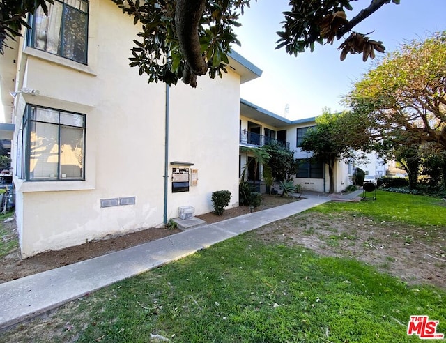 view of property exterior with a lawn