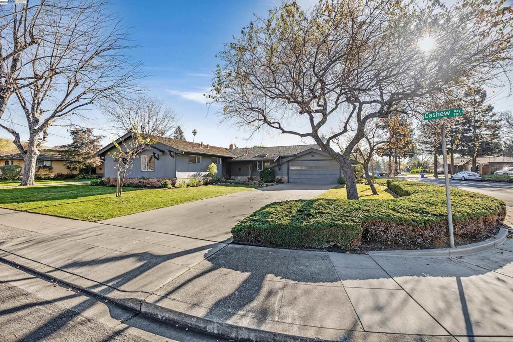 ranch-style house featuring a garage and a front yard