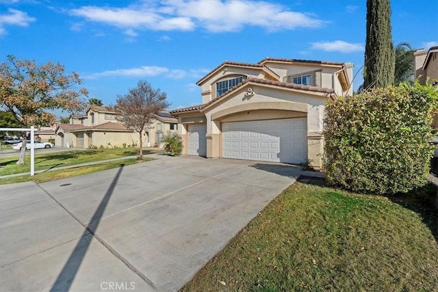 mediterranean / spanish house with a front yard and a garage