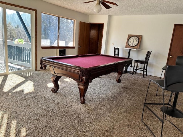 rec room with pool table, plenty of natural light, a textured ceiling, and carpet flooring