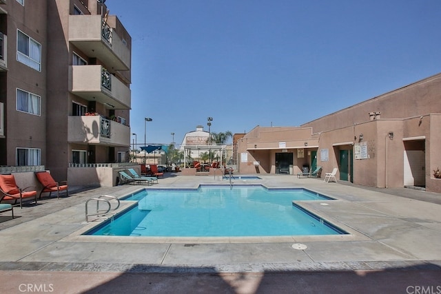 view of swimming pool with a patio