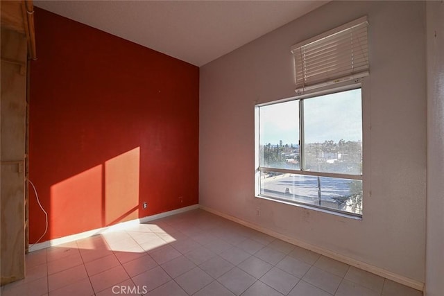 spare room featuring light tile patterned floors