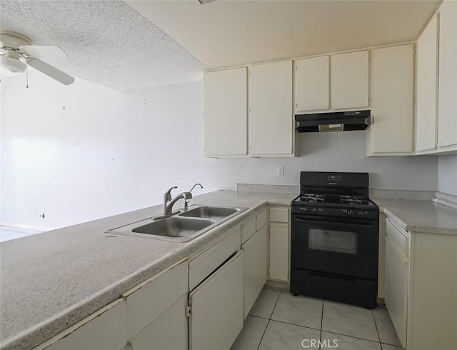 kitchen featuring sink, light tile patterned floors, ceiling fan, black gas stove, and a textured ceiling