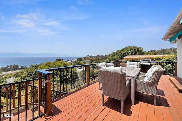 wooden deck featuring a water view