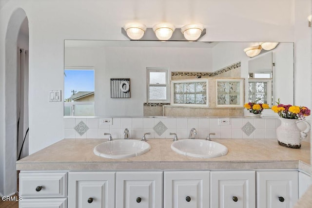 bathroom featuring tasteful backsplash and vanity