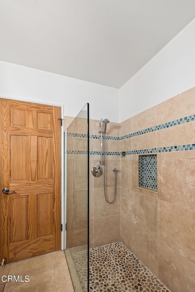 bathroom featuring tile patterned floors and tiled shower