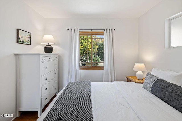 bedroom with dark hardwood / wood-style floors