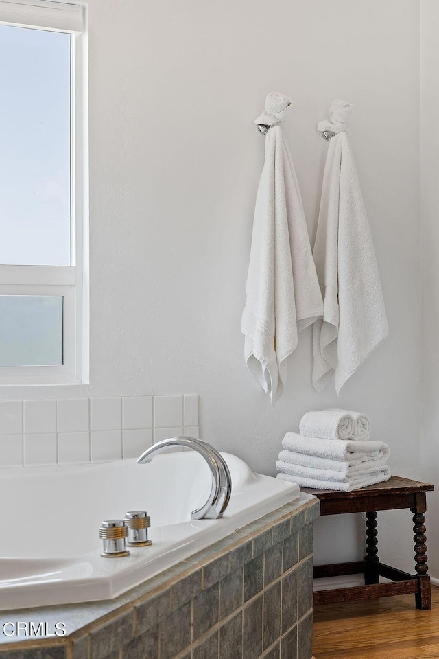 bathroom with tiled bath