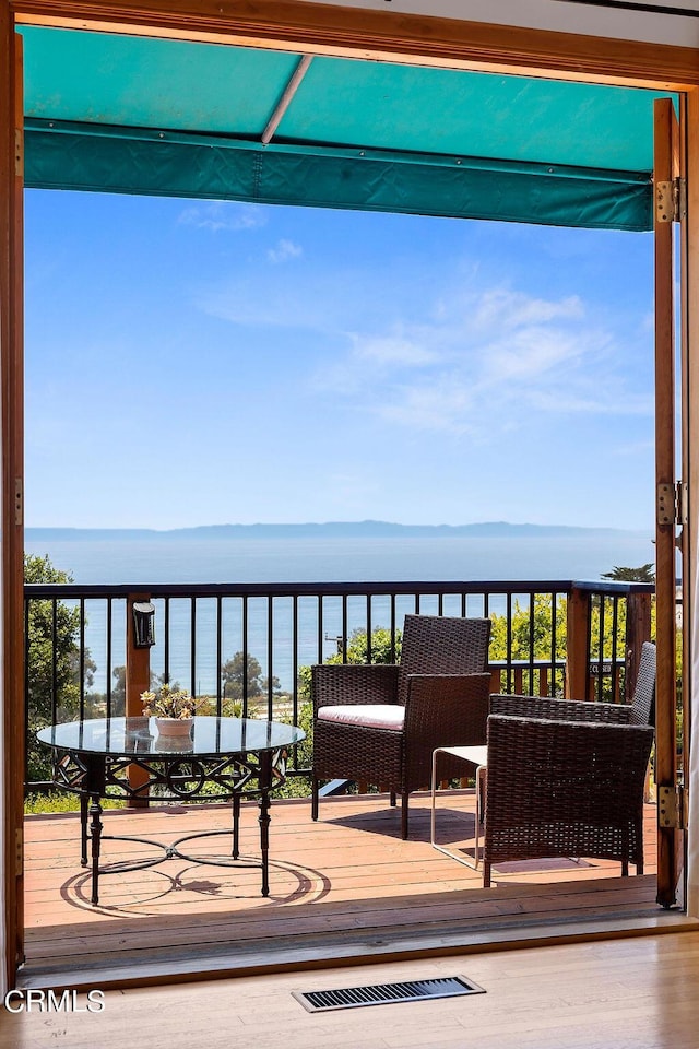 balcony featuring a water view