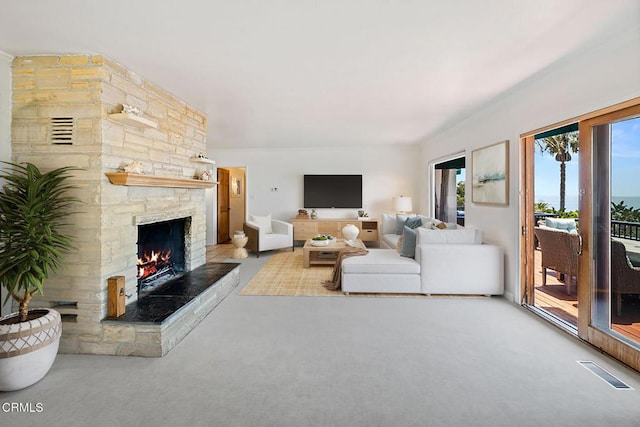 2335 Whitney Ave, Summerland, CA 93067 - living area featuring carpet flooring, a stone fireplace, and visible vents