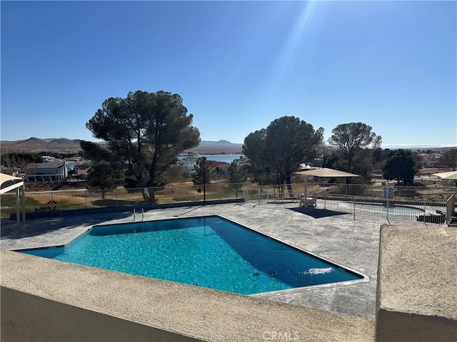 view of pool featuring a mountain view and a patio