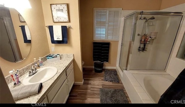 full bathroom featuring wood-type flooring, toilet, vanity, and plus walk in shower