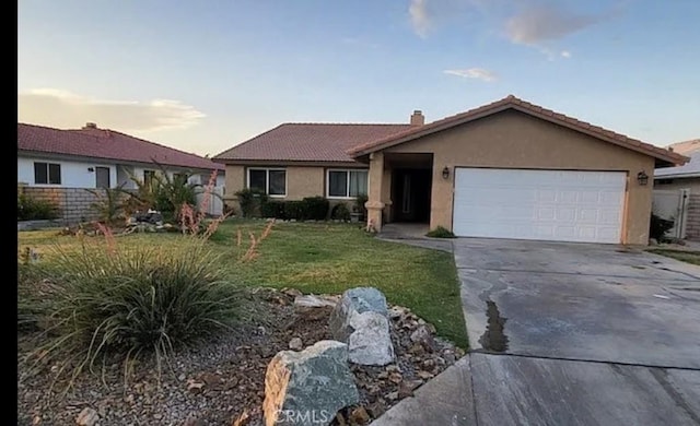 ranch-style home with a yard and a garage