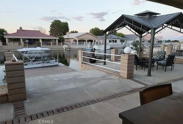 dock area with a water view and a gazebo