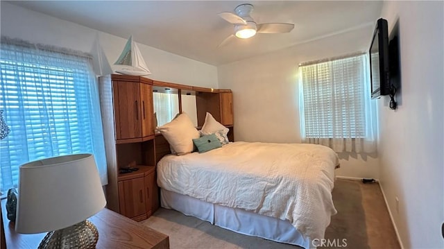 bedroom featuring ceiling fan and light colored carpet