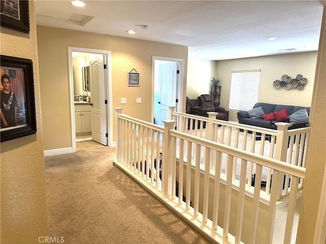 hall with light colored carpet